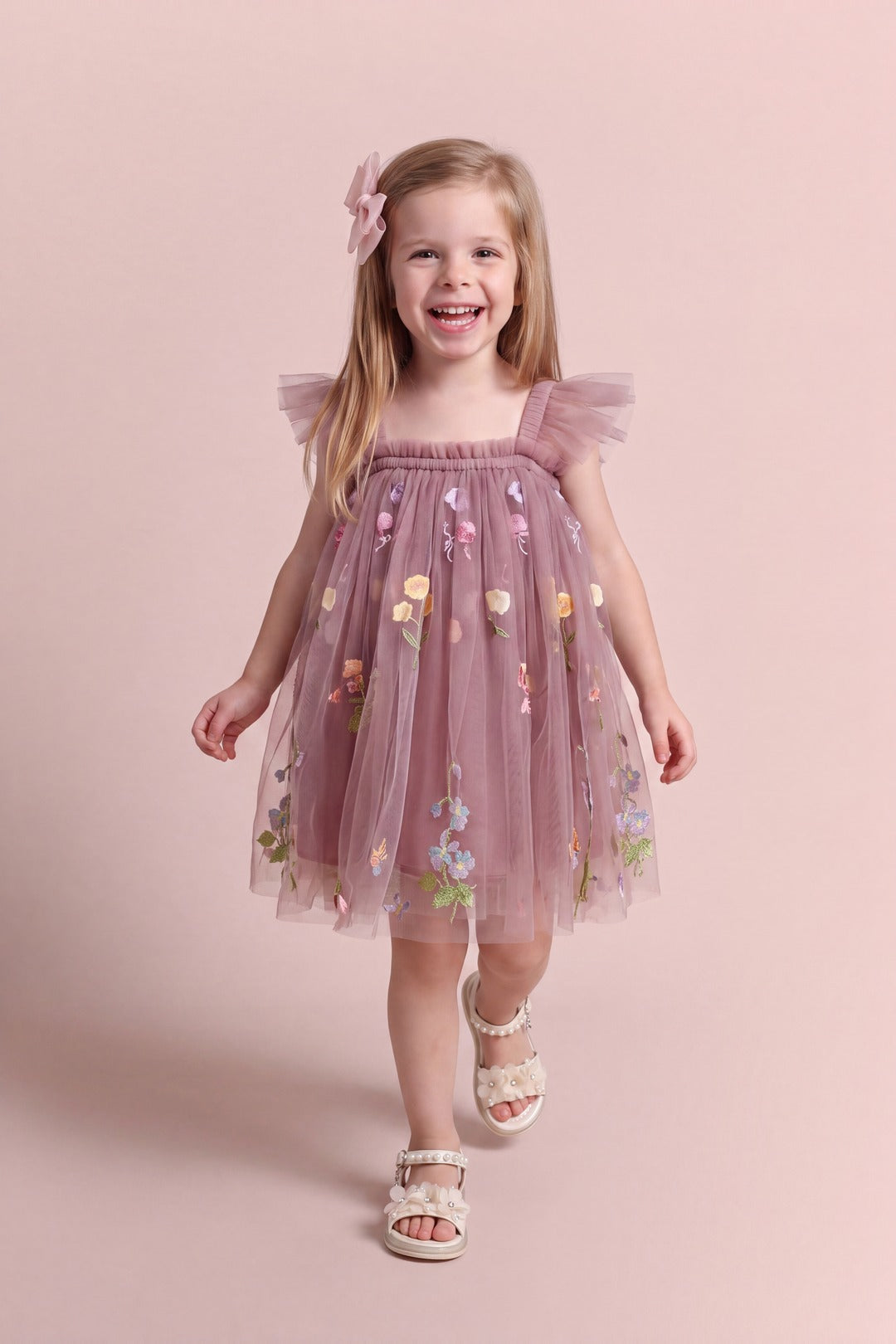 Girl wearing the Aurora Dress in dusty mauve embroidered floral tulle, front