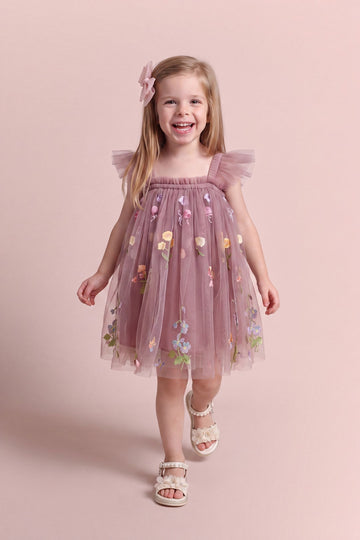 Girl wearing the Aurora Dress in dusty mauve embroidered floral tulle, front