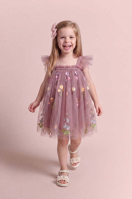 Girl wearing the Aurora Dress in dusty mauve embroidered floral tulle, front