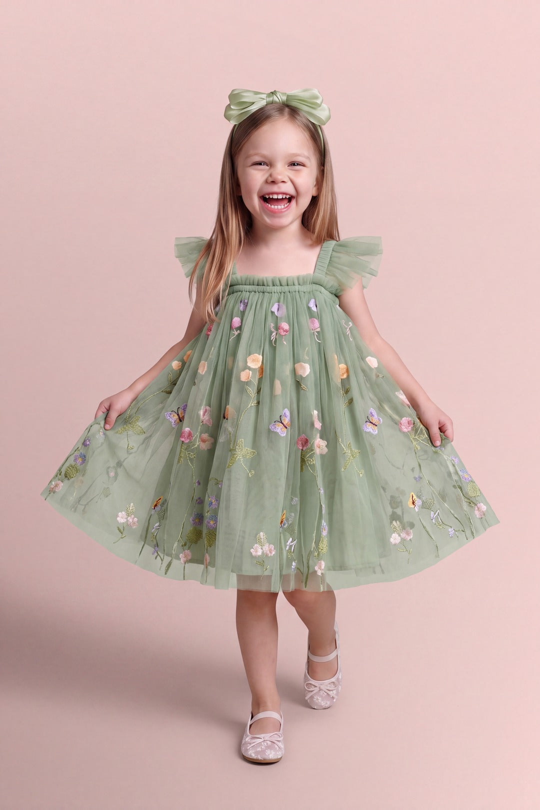 Girl wearing the Aurora Dress in sage green embroidered floral tulle, front