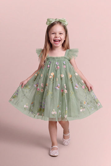 Girl wearing the Aurora Dress in sage green embroidered floral tulle, front