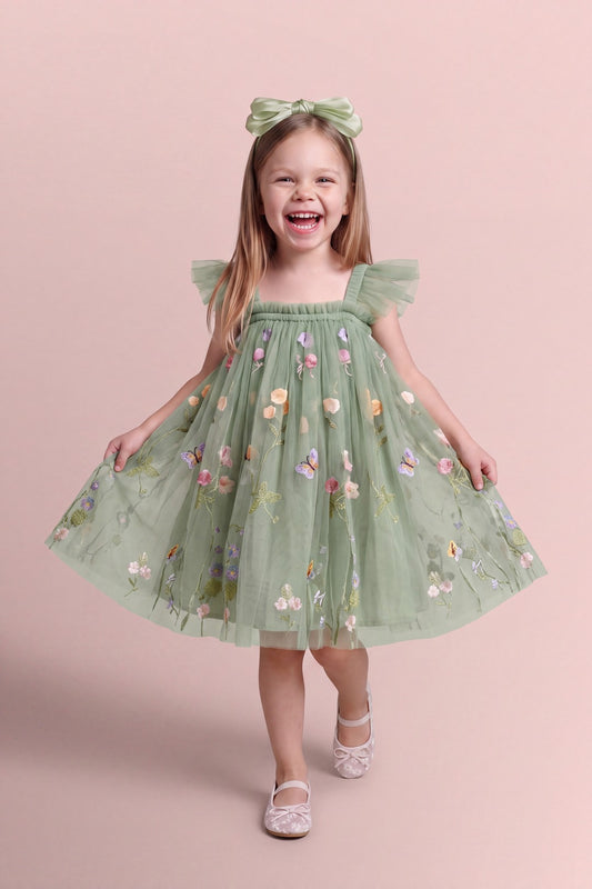 Girl wearing the Aurora Dress in sage green embroidered floral tulle, front
