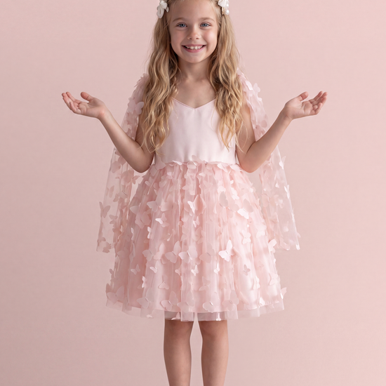 Blossom pink butterfly party dress, front view on a girl, satin sweetheart bodice and tulle skirt covered in 3D fabric butterflies