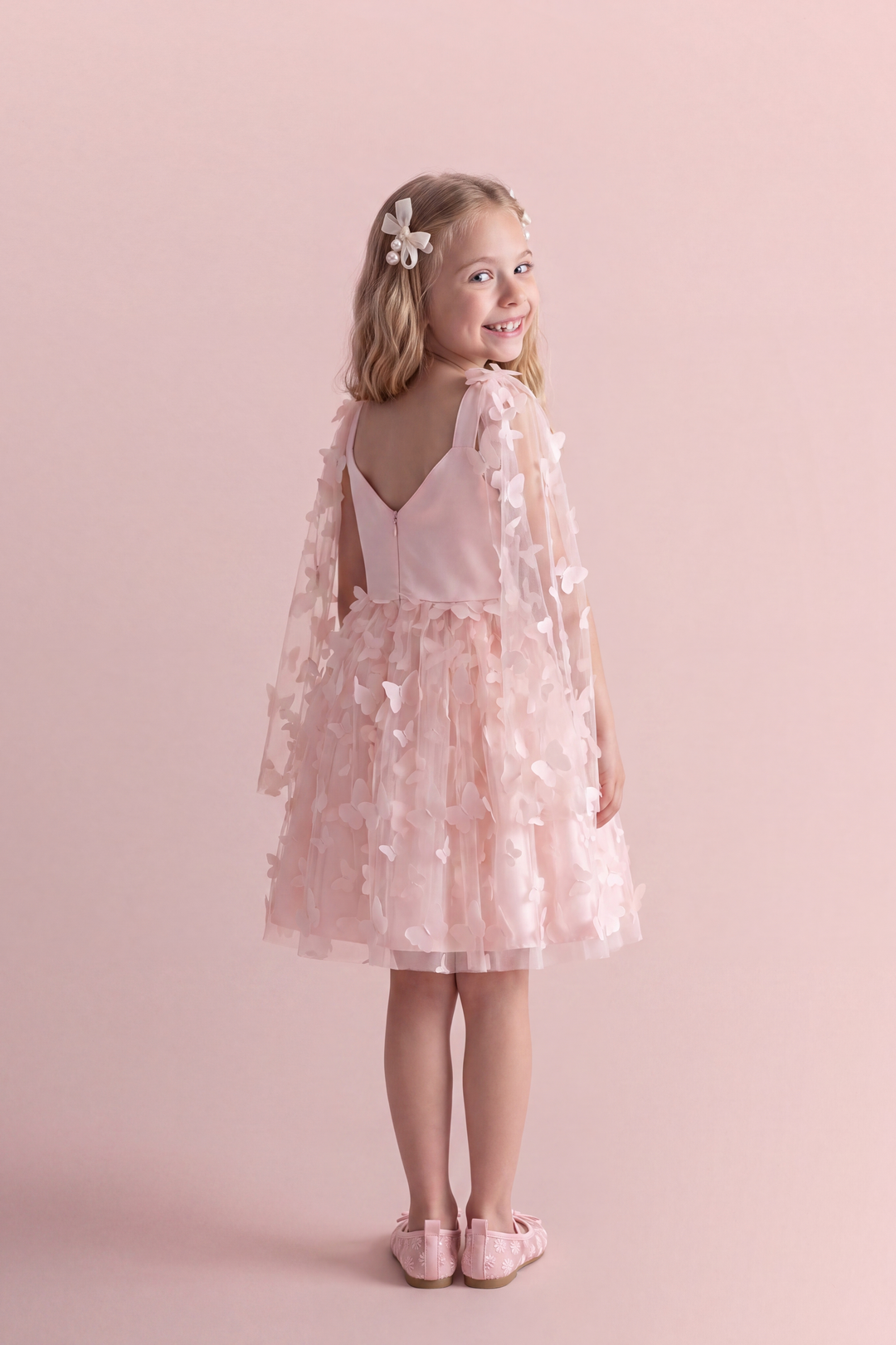 Blossom pink butterfly party dress, back view showing the low V back, satin straps and concealed zip