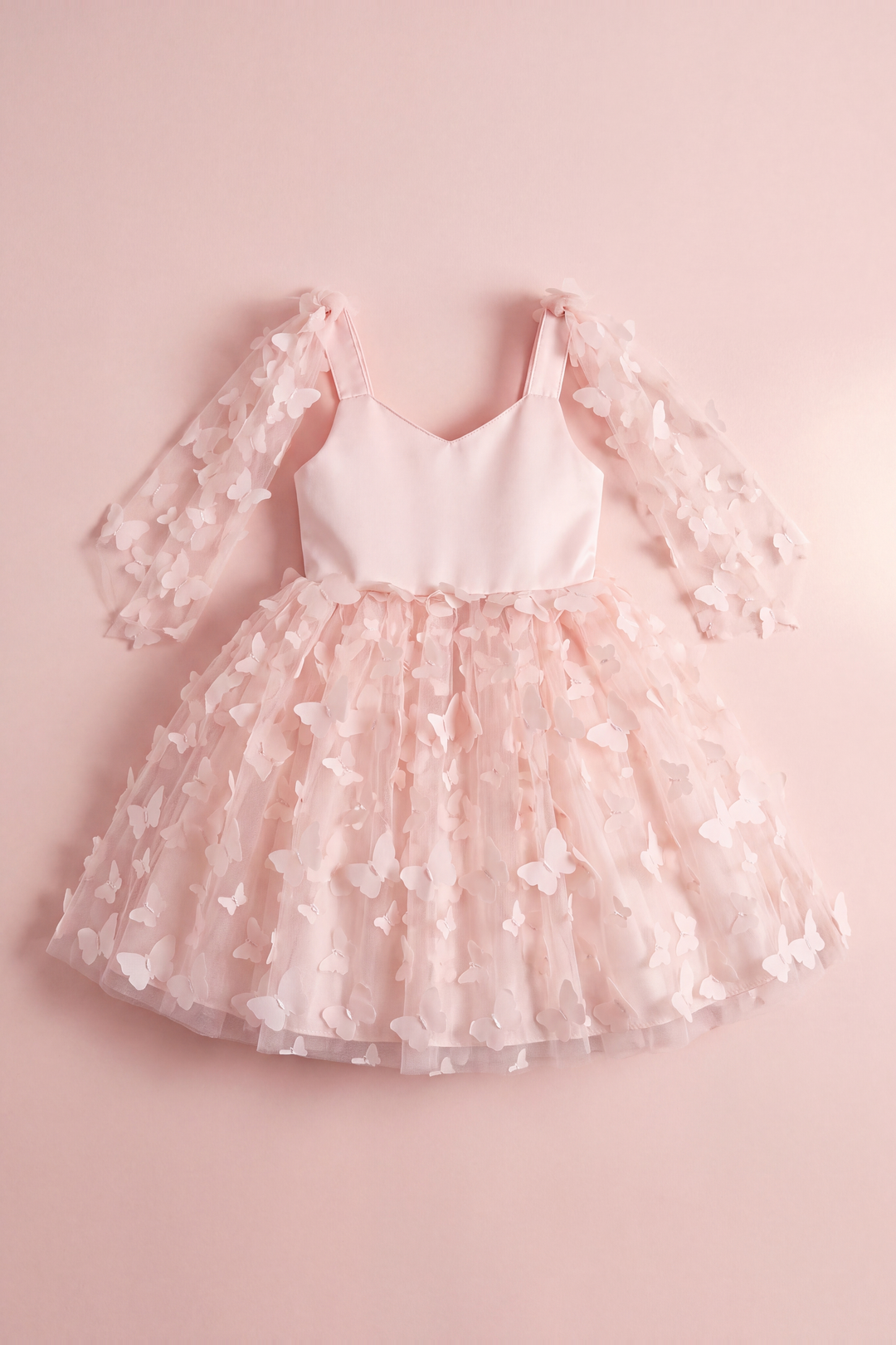 Blossom pink butterfly party dress laid flat, showing the satin bodice, wing panels and butterfly tulle skirt