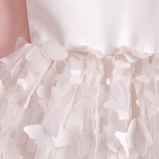 Close up of the Blossom white dress waist seam and the two layer fabric butterflies lifting off the tulle