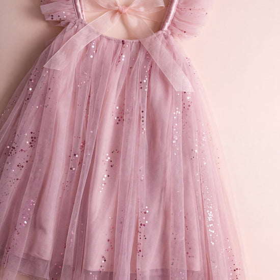 Bluebell pink dress laid flat, gathered neckline, frilled straps and back bow