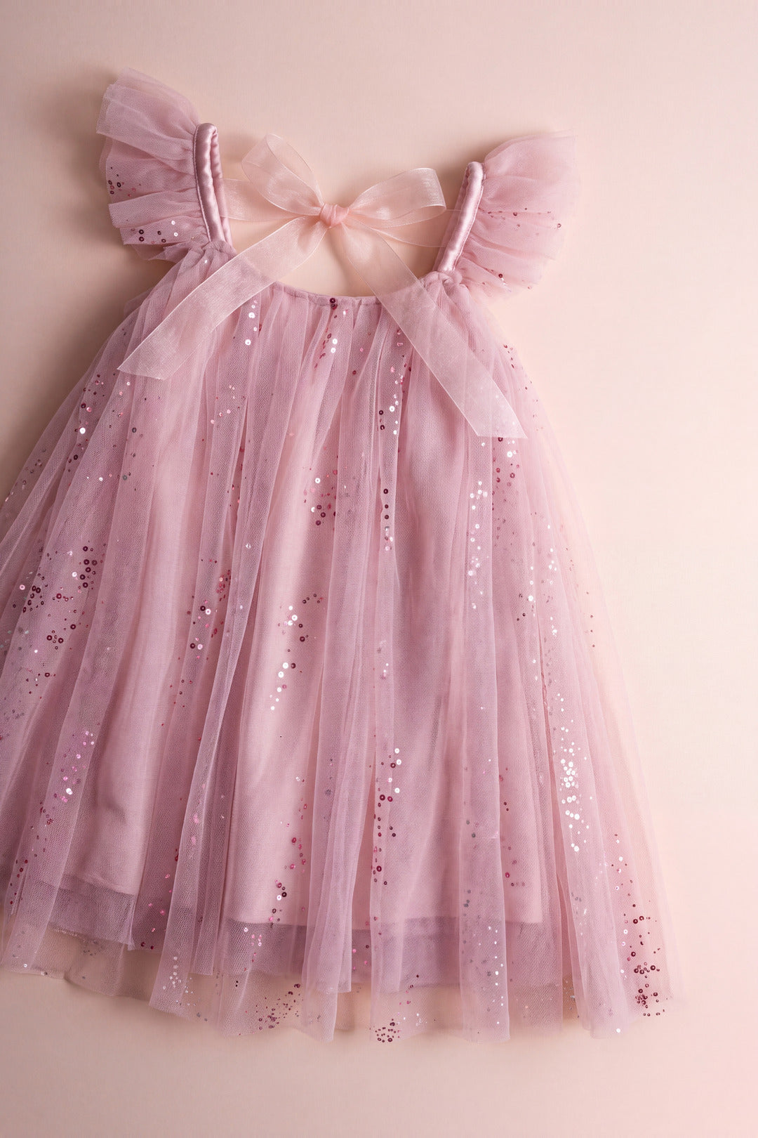 Bluebell pink dress laid flat, gathered neckline, frilled straps and back bow