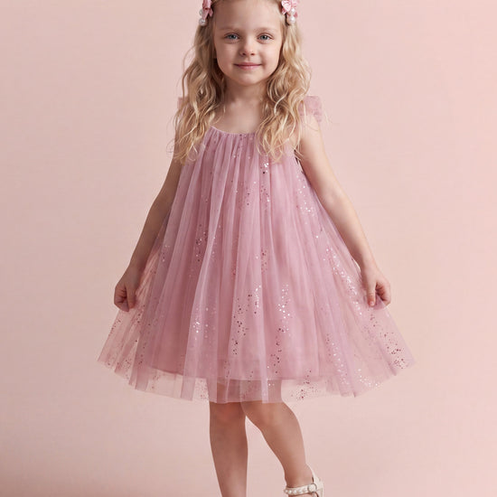 Girl wearing the Bluebell Pink Tulle Flower Girl Dress, front view