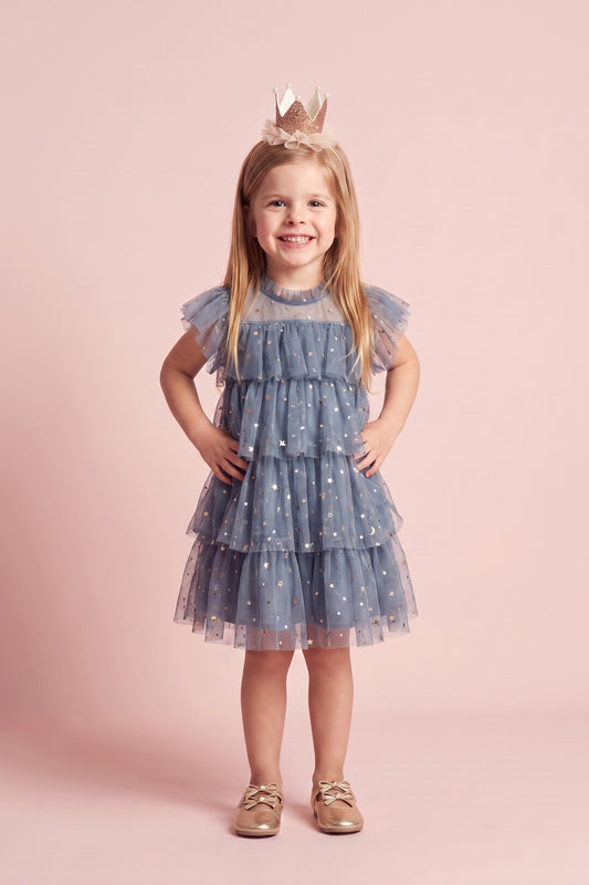 Girl wearing the Celeste Dress in dusty blue star and moon tulle, front