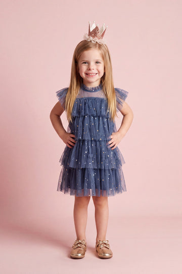 Girl wearing the Celeste Dress in denim blue star tulle, front