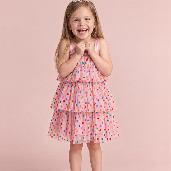 Girl wearing the Confetti Dot Pink Smocked Dress, front