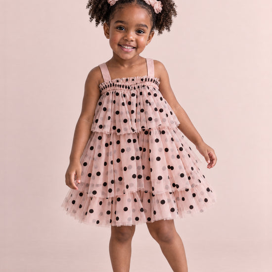 Girl wearing the Confetti Dot Blush Polka Dot Dress, front