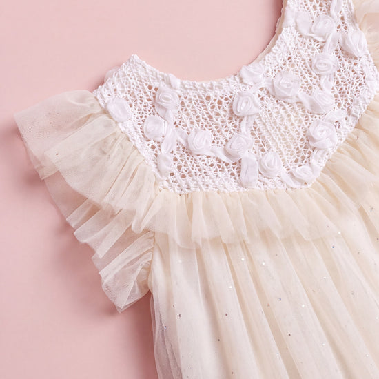 Detail of the Primrose dress, white crochet yoke with hand twisted gauze roses meeting warm cream tulle