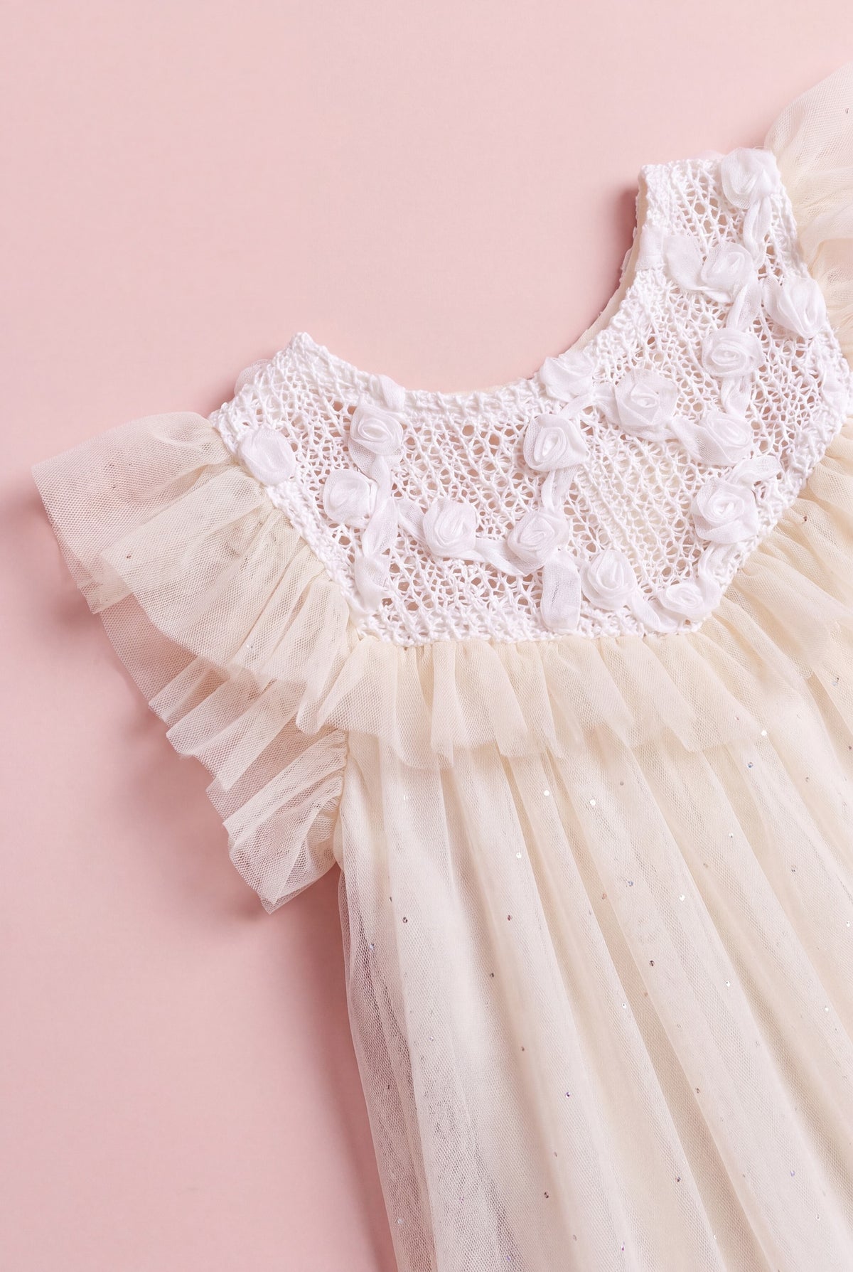 Detail of the Primrose dress, white crochet yoke with hand twisted gauze roses meeting warm cream tulle