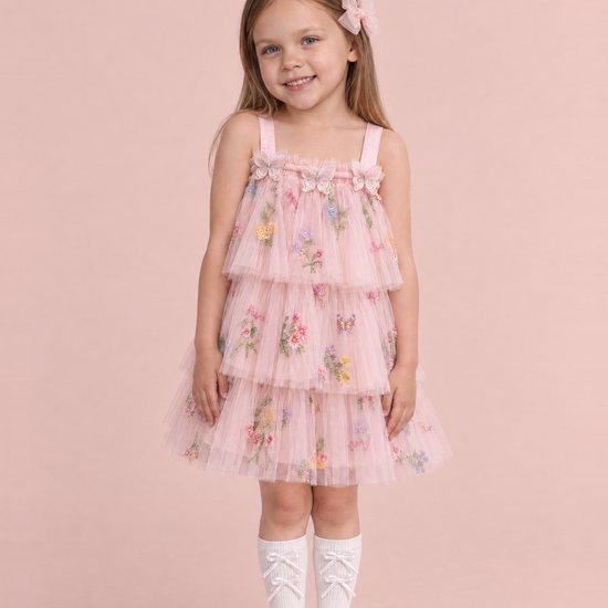 Girl wearing the Flutter Blush Butterfly Flower Girl Dress, front