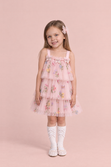 Girl wearing the Flutter Blush Butterfly Flower Girl Dress, front