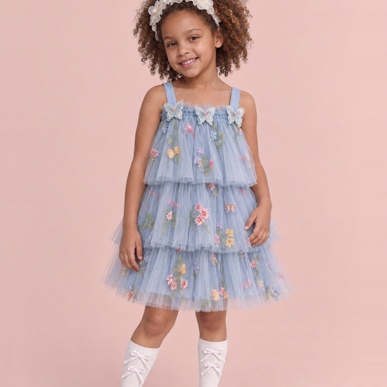 Girl wearing the Flutter Dusty Blue Butterfly Flower Girl Dress, front