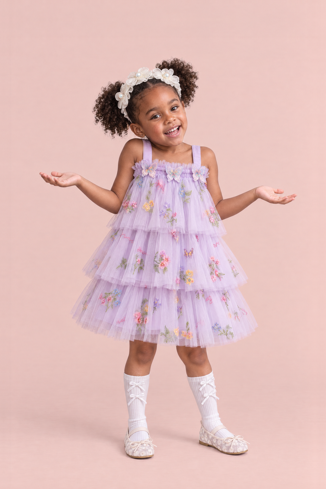Girl wearing the Flutter Lilac Butterfly Flower Girl Dress, front, a big shrug