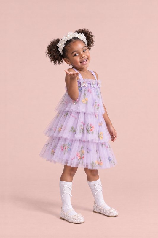 Flutter Lilac Butterfly Flower Girl Dress, three quarter, blowing a kiss, organza butterflies and tiers