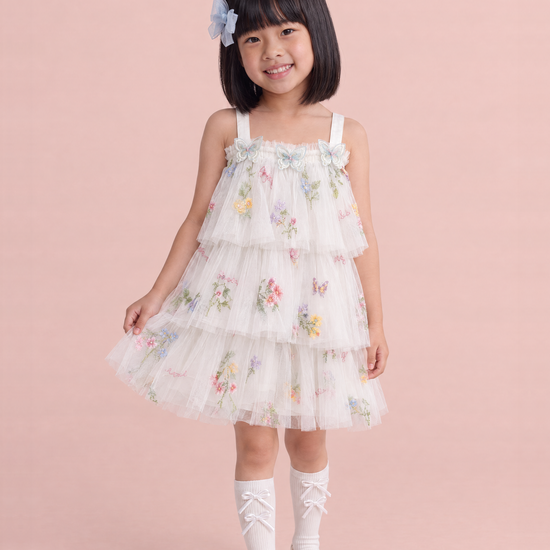 Girl wearing the Flutter White Butterfly Flower Girl Dress, front