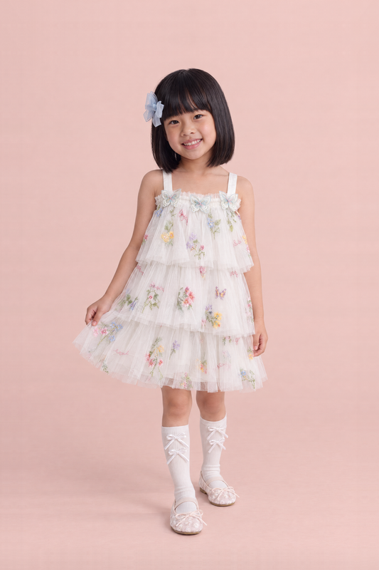 Girl wearing the Flutter White Butterfly Flower Girl Dress, front