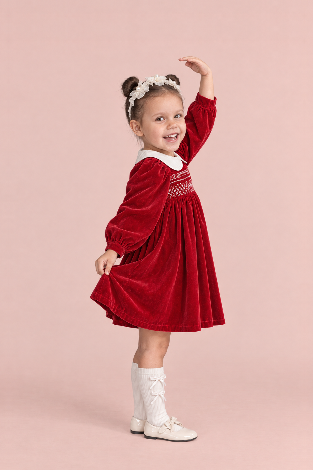 Holly Red Velvet Christmas Dress, side view in a ballerina pose, showing the long puff sleeve and the full gathered skirt