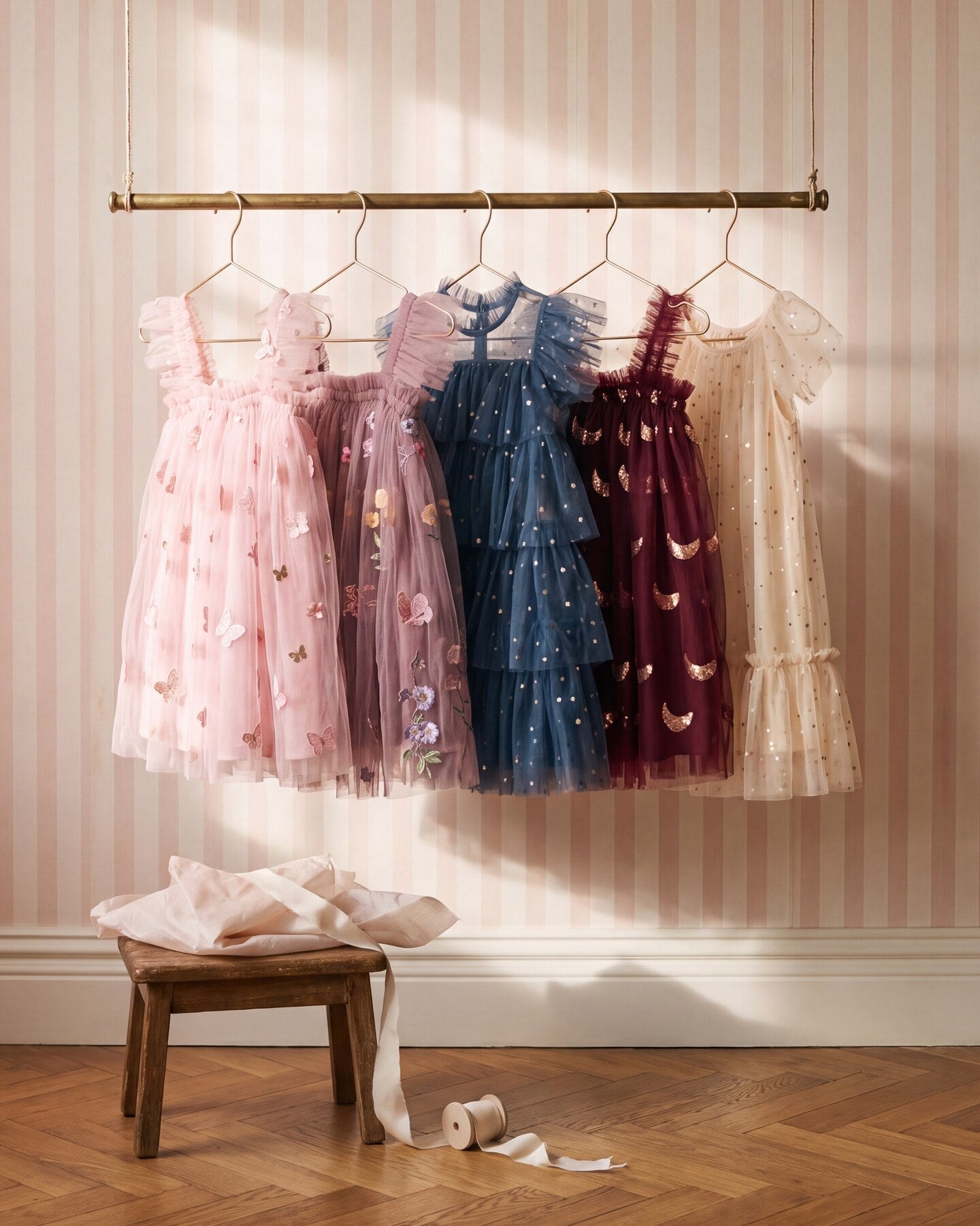 Five K for Kaia girls tulle dresses hanging on a brass rail