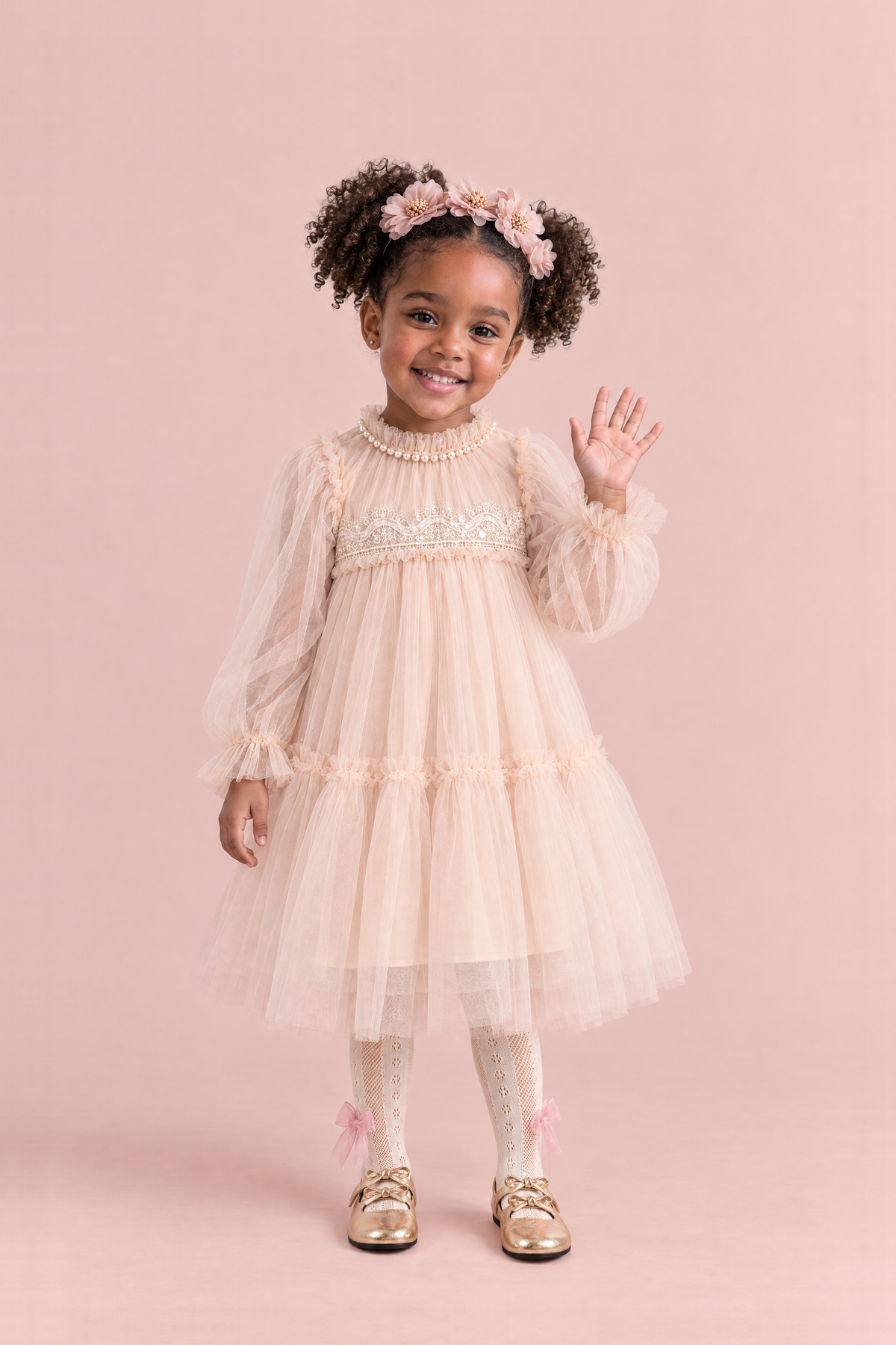 Girl wearing the Magnolia Champagne Long Sleeve Flower Girl Dress, front