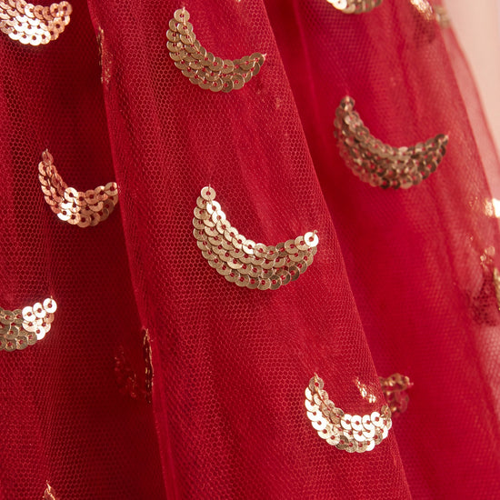 Close up of the red tulle and gold crescent moon sequins