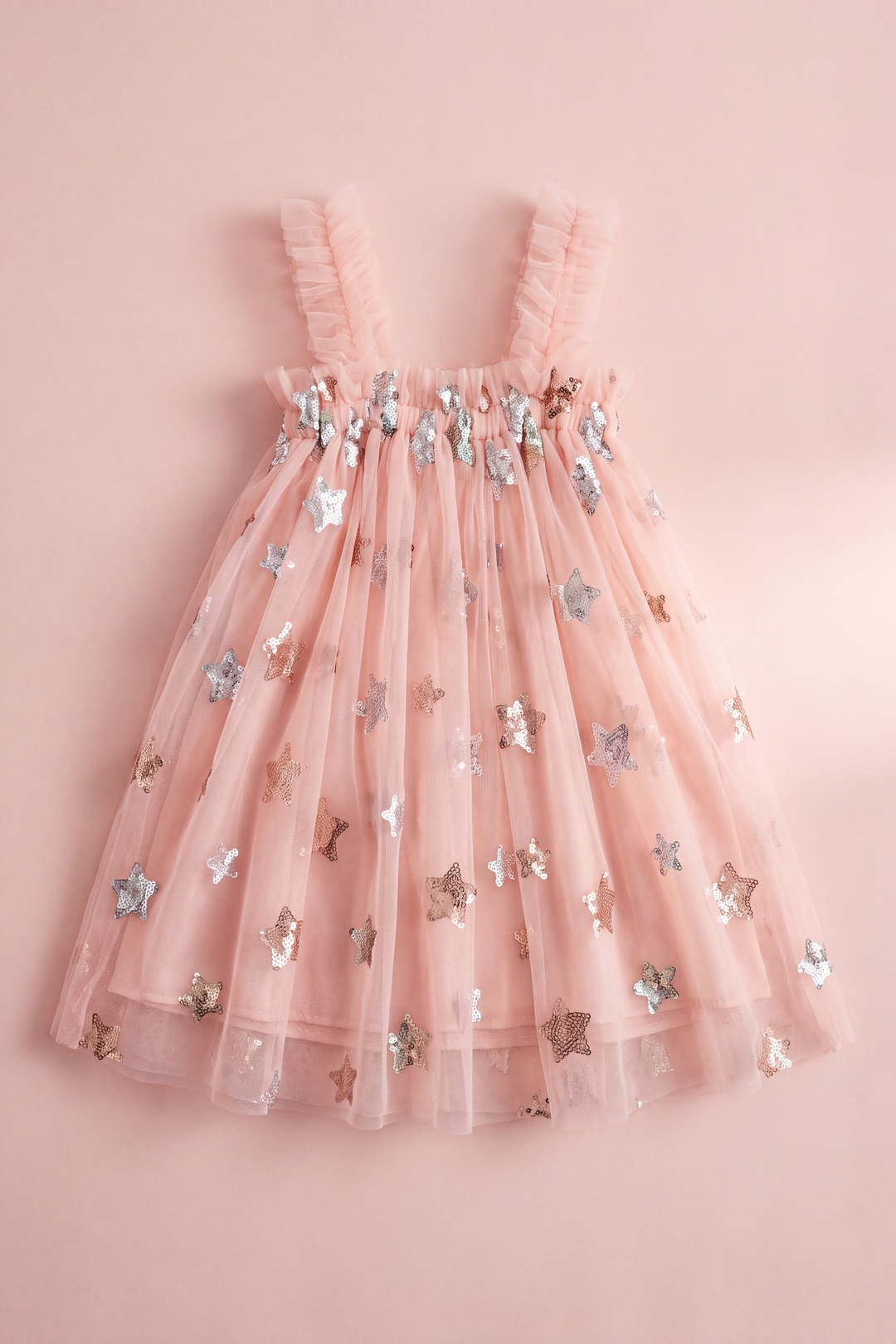 Midnight pink formal dress laid flat, showing the frilled top edge, ruffled straps and two layers of star sequin tulle