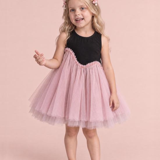 Girl wearing the Odette Black and Pink Tutu Party Dress, front, chatting mid sentence