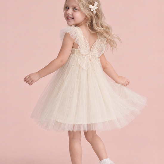 Papillon Ivory Butterfly Back Flower Girl Dress, turning to show the organza butterfly across her back