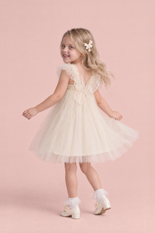 Papillon Ivory Butterfly Back Flower Girl Dress, turning to show the organza butterfly across her back