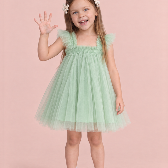 Girl wearing the Papillon Mint Butterfly Back Flower Girl Dress, front, holding up five fingers