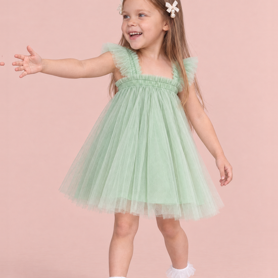 Papillon Mint Butterfly Back Flower Girl Dress, three quarter view, reaching out to the side