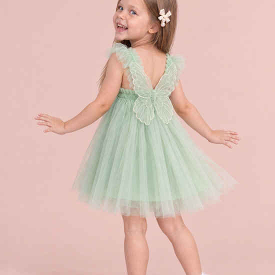 Papillon Mint Butterfly Back Flower Girl Dress, back, dancing with her hands out, one large organza butterfly between the straps