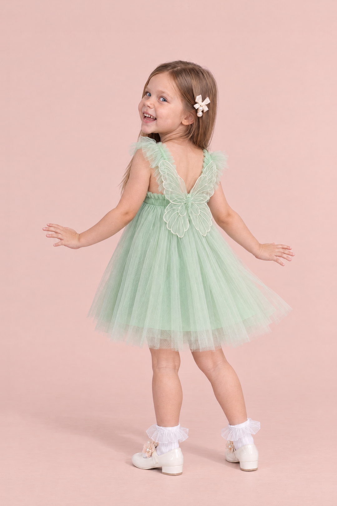 Papillon Mint Butterfly Back Flower Girl Dress, back, dancing with her hands out, one large organza butterfly between the straps