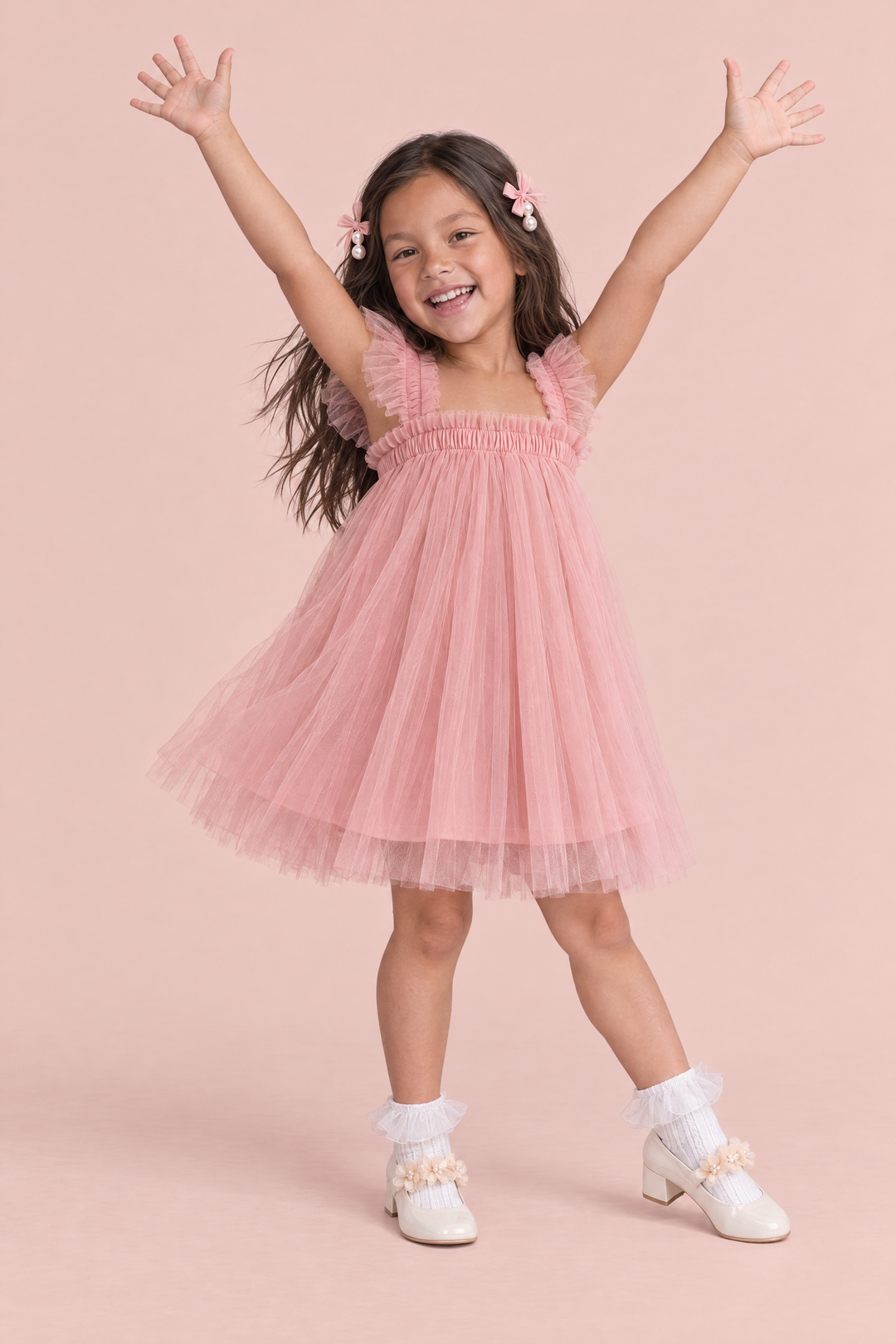 Girl wearing the Papillon Dusty Rose Butterfly Back Flower Girl Dress, front, arms up in a ta da