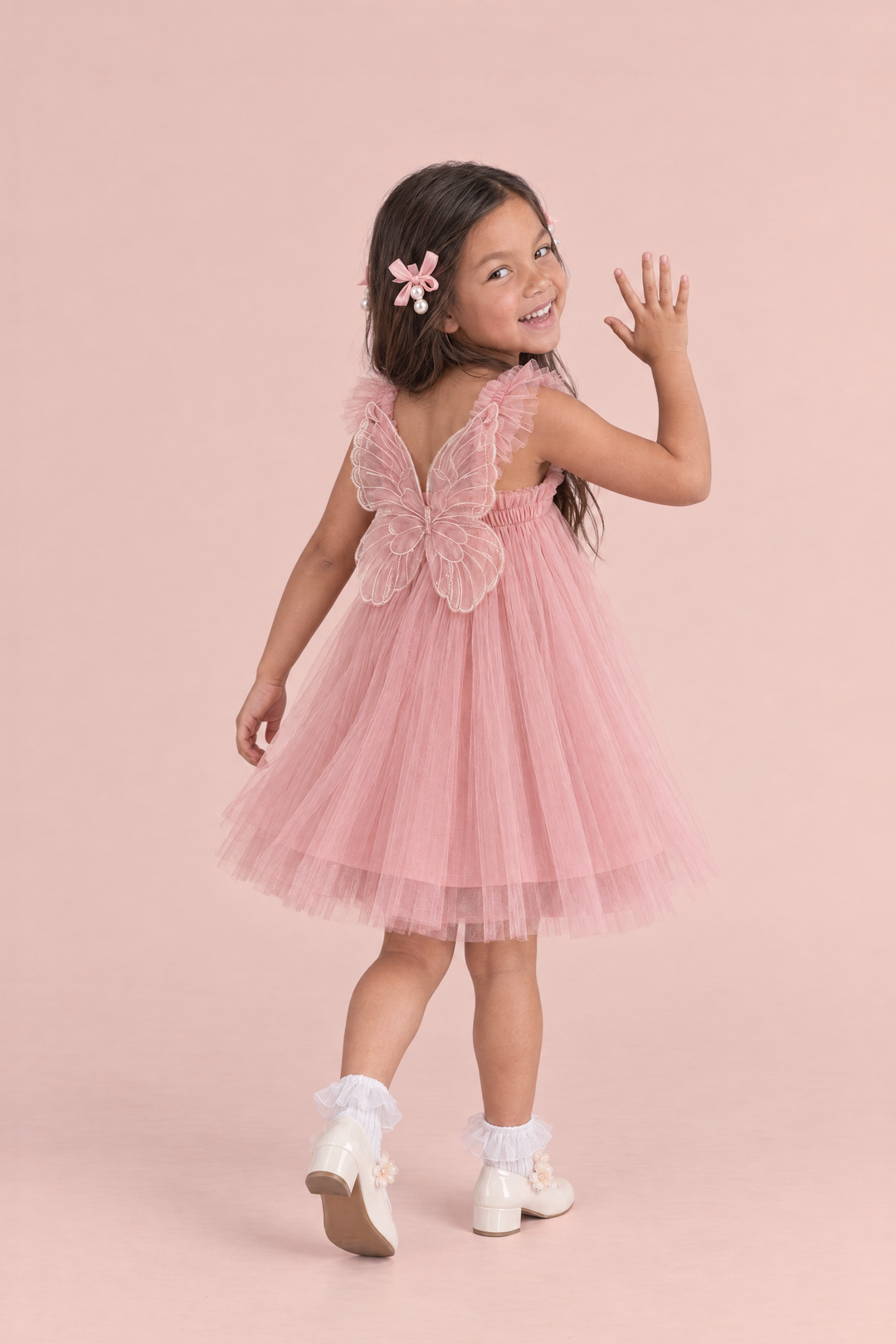 Papillon Dusty Rose Butterfly Back Flower Girl Dress, walking away and waving back, the organza butterfly across her back
