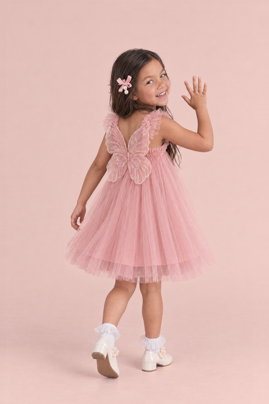 Papillon Dusty Rose Butterfly Back Flower Girl Dress, walking away and waving back, the organza butterfly across her back