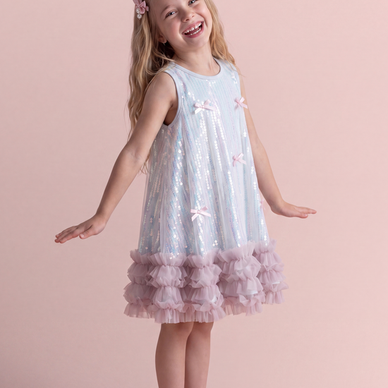Periwinkle blue sequin party dress, three quarter view showing the swing shape and ruffle hem
