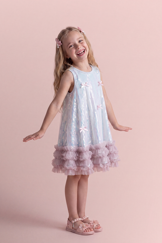 Periwinkle blue sequin party dress, three quarter view showing the swing shape and ruffle hem