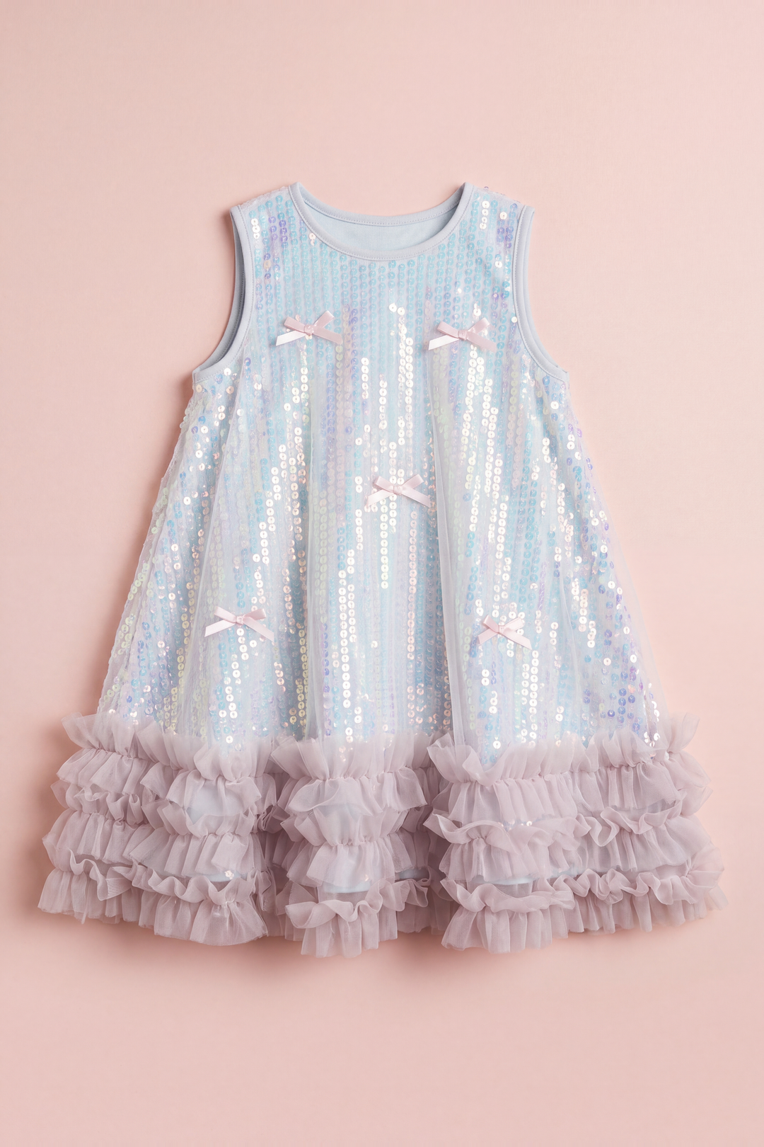 Periwinkle blue sequin party dress laid flat, showing the sequin rows, bows and ruffle hem