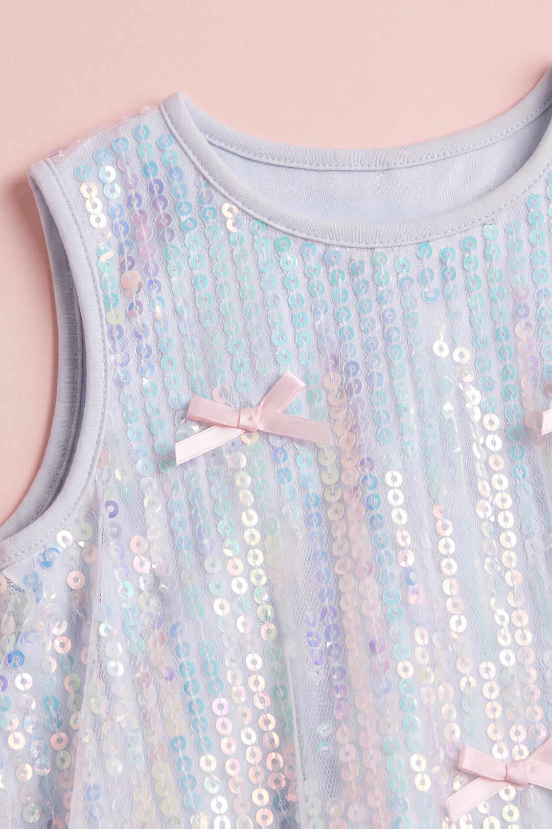 Close up of the Periwinkle dress neckline, iridescent sequins and a satin bow