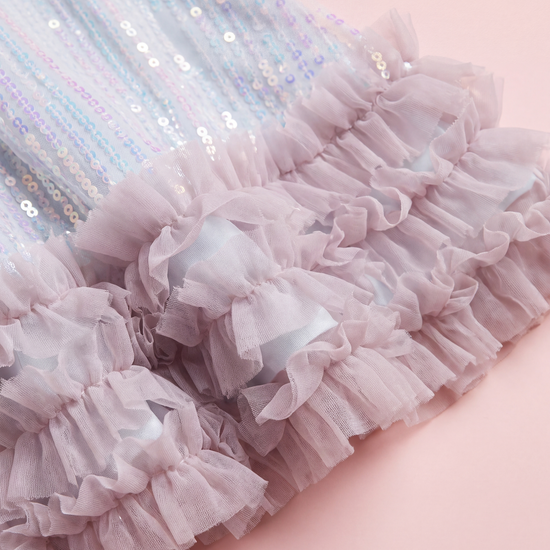 Close up of the Periwinkle dress hem, three tiers of pink tulle ruffles below the sequins