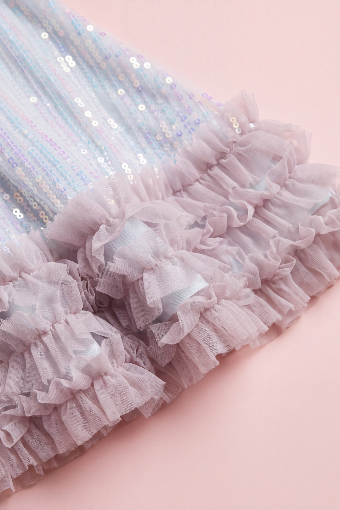 Close up of the Periwinkle dress hem, three tiers of pink tulle ruffles below the sequins