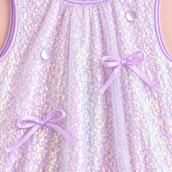 Close up of the lavender iridescent sequins, satin bows and satin neck piping