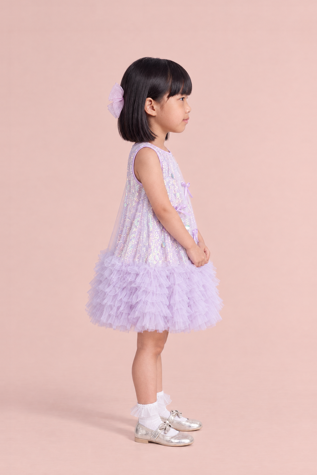 Periwinkle Lavender Sequin Party Dress, side view showing the A line swing shape and the tulle ruffle hem