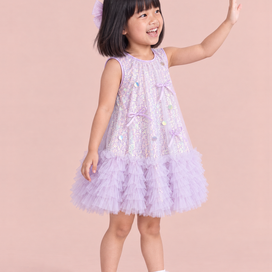 Periwinkle Lavender Sequin Party Dress, three quarter view with satin bows and sequin discs on the front